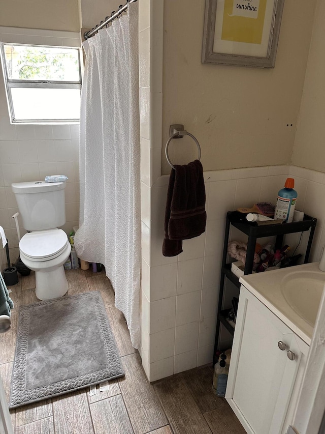 508 Palmetto St, West Palm Beach, FL 33405 - bathroom featuring a shower with curtain, a wainscoted wall, wood finished floors, and toilet