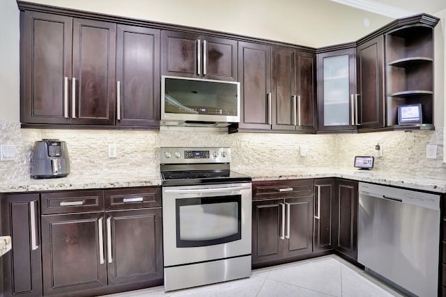 kitchen with open shelves, decorative backsplash, light stone counters, appliances with stainless steel finishes, and light tile patterned floors