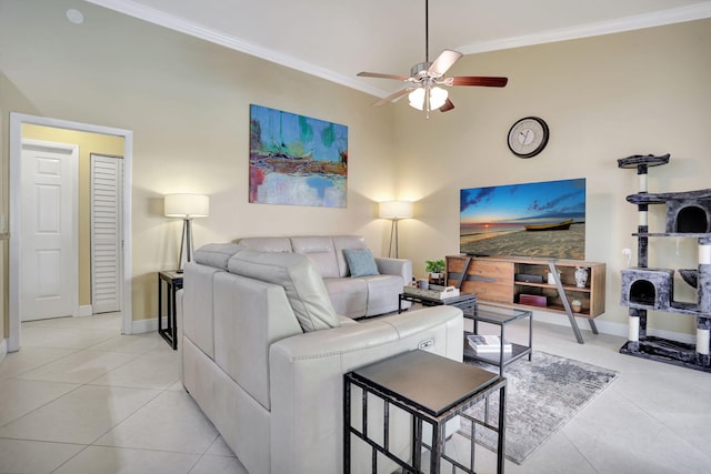 living room featuring crown molding, baseboards, ceiling fan, and light tile patterned floors