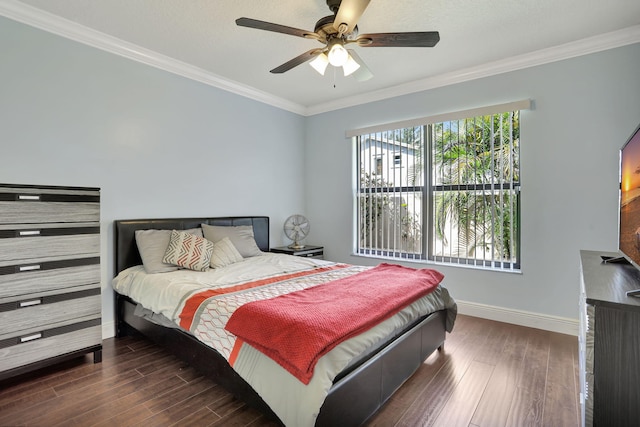 bedroom with baseboards, ornamental molding, a ceiling fan, and wood finished floors