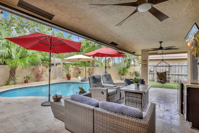 view of pool featuring a patio, a ceiling fan, a fenced backyard, and a fenced in pool