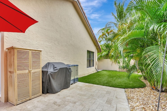view of patio with a fenced backyard and a grill