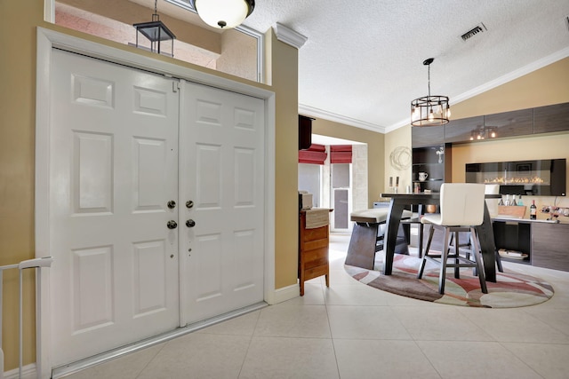 385 NW 37th Way, Deerfield Beach, FL 33442 - foyer featuring ornamental molding, a textured ceiling, tile patterned flooring, lofted ceiling, and a chandelier