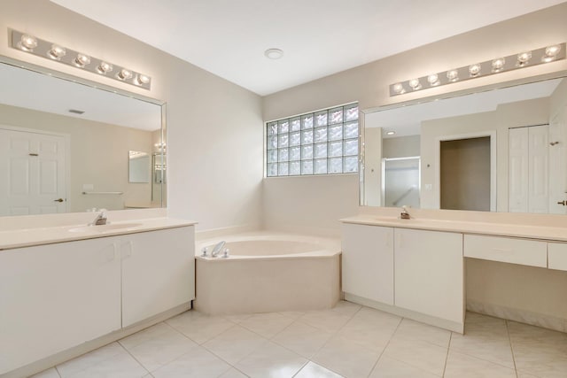 bathroom featuring two vanities, a bath, a sink, and a stall shower