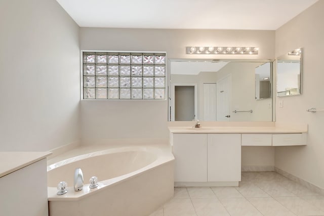 bathroom with a bath, tile patterned flooring, and vanity