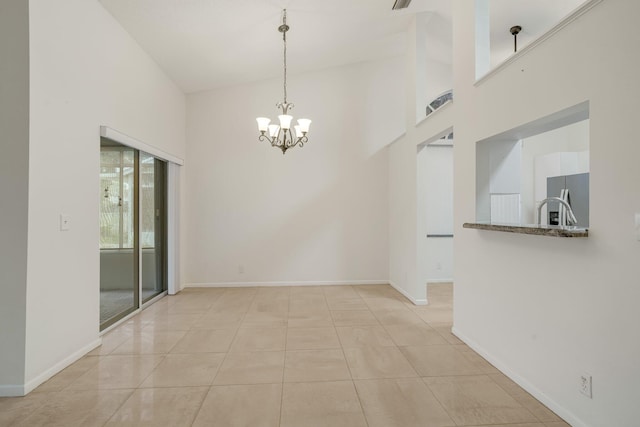 6209 Pond Tree Ct, Greenacres, FL 33463 - spare room with a chandelier, a towering ceiling, baseboards, and light tile patterned floors