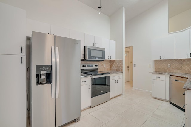 6209 Pond Tree Ct, Greenacres, FL 33463 - kitchen with appliances with stainless steel finishes, backsplash, high vaulted ceiling, white cabinets, and light tile patterned floors