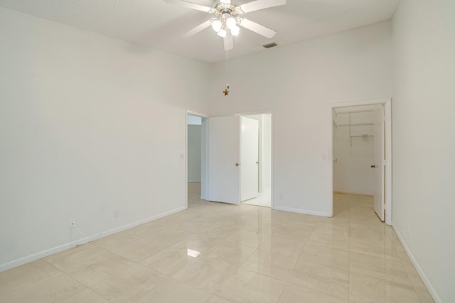 6209 Pond Tree Ct, Greenacres, FL 33463 - unfurnished bedroom featuring a spacious closet, a high ceiling, baseboards, light tile patterned flooring, and ceiling fan