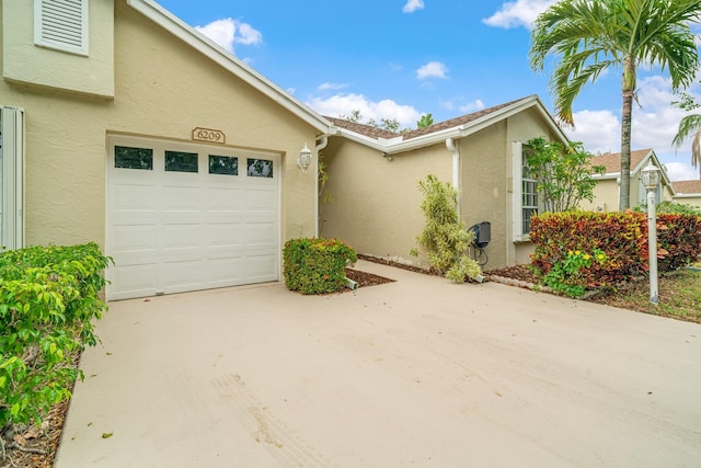 6209 Pond Tree Ct, Greenacres, FL 33463 - townhome / multi-family property with stucco siding, concrete driveway, and an attached garage
