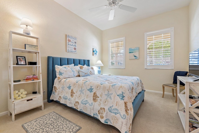 carpeted bedroom featuring baseboards and ceiling fan
