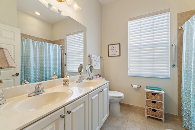 bathroom with tile patterned flooring, plenty of natural light, and a sink