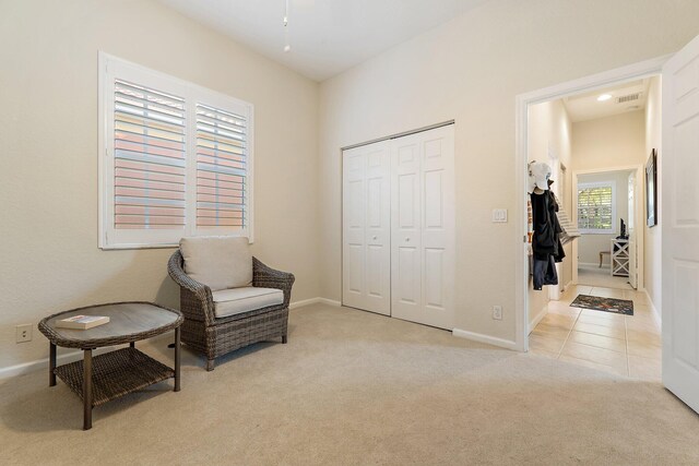 sitting room featuring baseboards, carpet, and ceiling fan