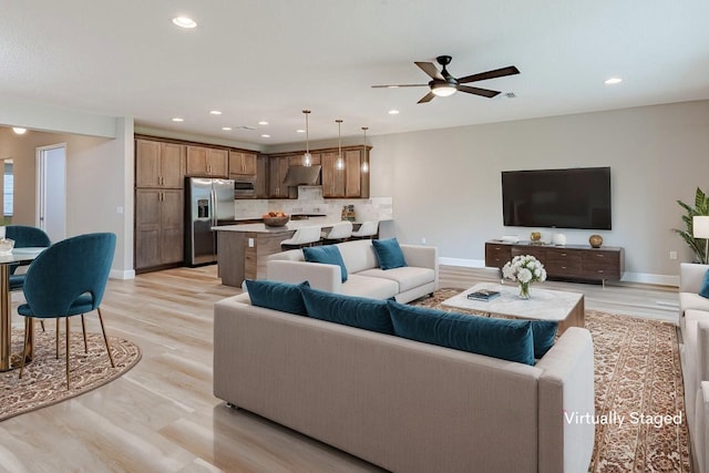 13509 SW Oceanus Blvd, Port Saint Lucie, FL 34987 - living area with recessed lighting, ceiling fan, light wood-style floors, and baseboards