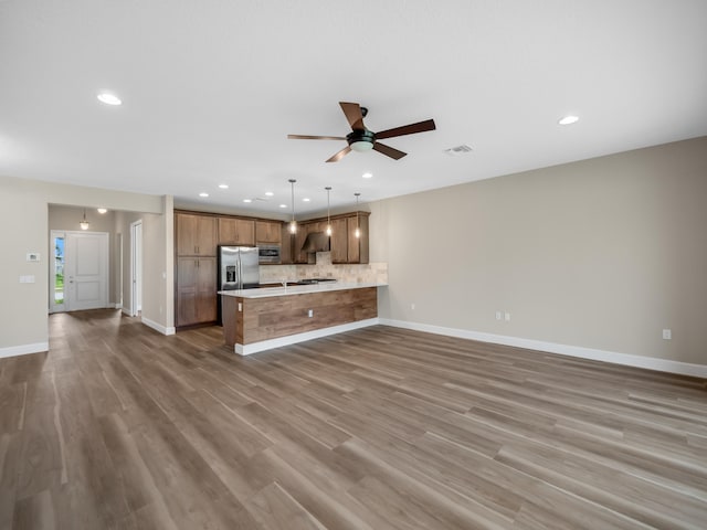 13509 SW Oceanus Blvd, Port Saint Lucie, FL 34987 - unfurnished living room with recessed lighting, a ceiling fan, baseboards, and wood finished floors