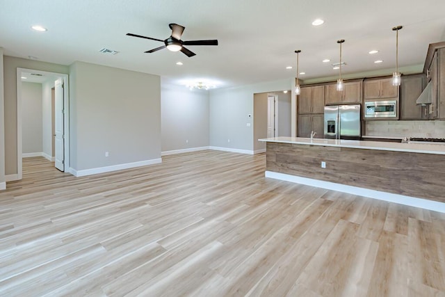 13509 SW Oceanus Blvd, Port Saint Lucie, FL 34987 - unfurnished living room featuring recessed lighting, ceiling fan, baseboards, and light wood finished floors