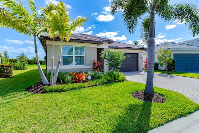 13509 SW Oceanus Blvd, Port Saint Lucie, FL 34987 - view of front facade with stucco siding, a garage, driveway, and a front yard