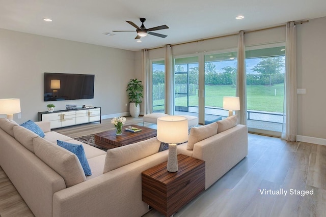 13509 SW Oceanus Blvd, Port Saint Lucie, FL 34987 - living area featuring baseboards, light wood-style flooring, ceiling fan, and recessed lighting
