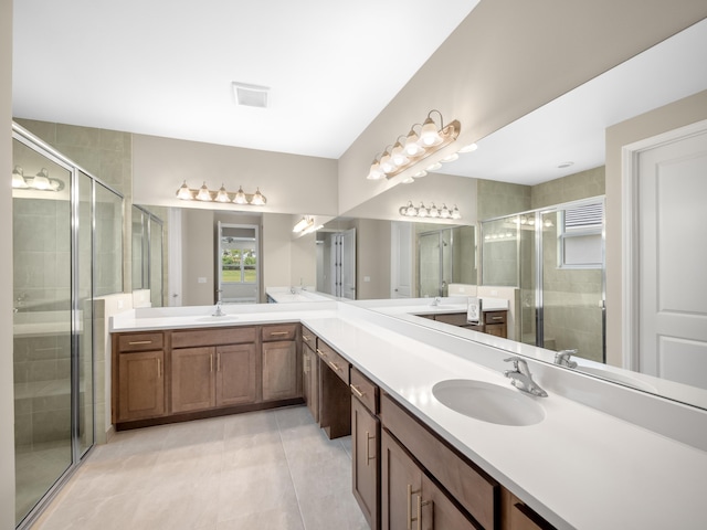 13509 SW Oceanus Blvd, Port Saint Lucie, FL 34987 - bathroom with tile patterned floors, a stall shower, and double vanity