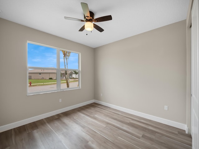 13509 SW Oceanus Blvd, Port Saint Lucie, FL 34987 - spare room with wood finished floors, baseboards, and ceiling fan