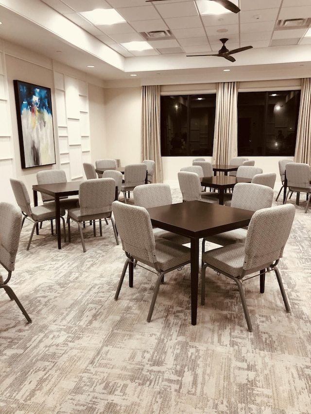 13509 SW Oceanus Blvd, Port Saint Lucie, FL 34987 - dining room featuring light carpet, ceiling fan, and a drop ceiling