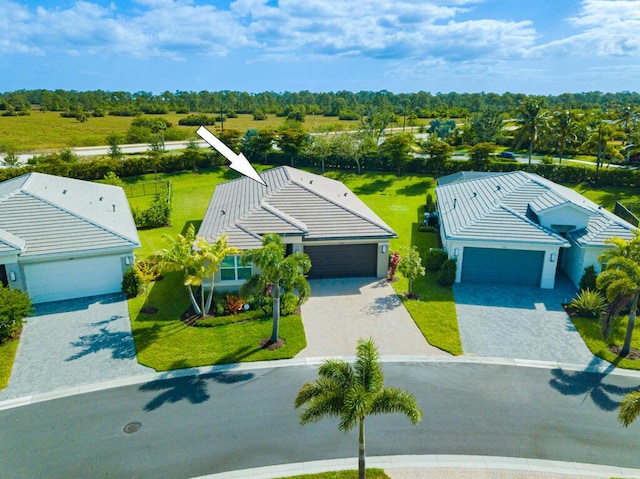 13509 SW Oceanus Blvd, Port Saint Lucie, FL 34987 - aerial view of property and surrounding area with a tree filled landscape