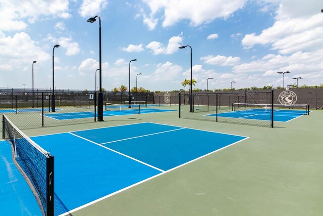 13509 SW Oceanus Blvd, Port Saint Lucie, FL 34987 - view of tennis court with community basketball court and fence