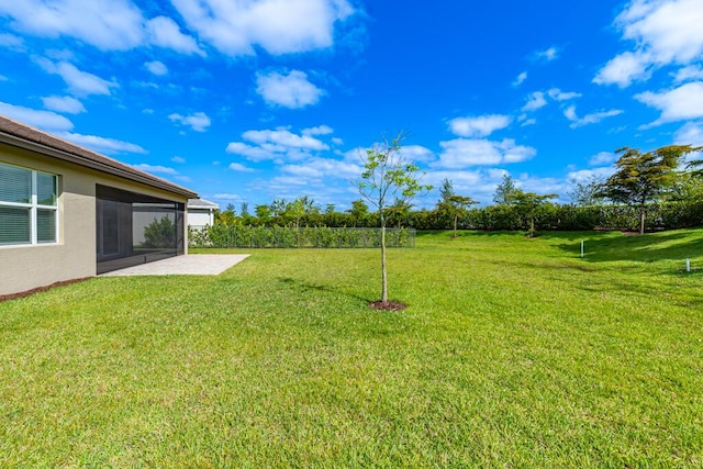 13509 SW Oceanus Blvd, Port Saint Lucie, FL 34987 - view of green lawn with a patio area and a sunroom