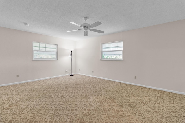 1904 6th Ave SE, Vero Beach, FL 32962 - empty room featuring a textured ceiling, carpet, a wealth of natural light, and a ceiling fan