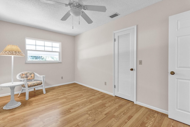1904 6th Ave SE, Vero Beach, FL 32962 - living area featuring a ceiling fan, wood finished floors, visible vents, and a textured ceiling