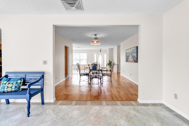 1904 6th Ave SE, Vero Beach, FL 32962 - dining room featuring baseboards, a textured ceiling, and visible vents