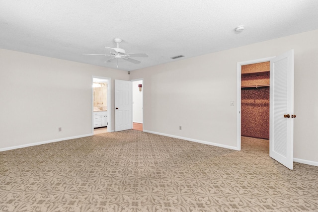 1904 6th Ave SE, Vero Beach, FL 32962 - unfurnished bedroom featuring visible vents, connected bathroom, a walk in closet, a closet, and baseboards