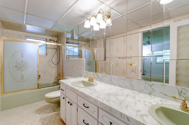 1904 6th Ave SE, Vero Beach, FL 32962 - full bathroom with double vanity, tile patterned floors, bath / shower combo with glass door, and a sink