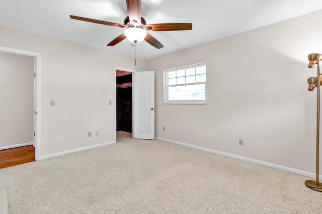 1904 6th Ave SE, Vero Beach, FL 32962 - unfurnished bedroom featuring a spacious closet, a closet, baseboards, carpet flooring, and ceiling fan