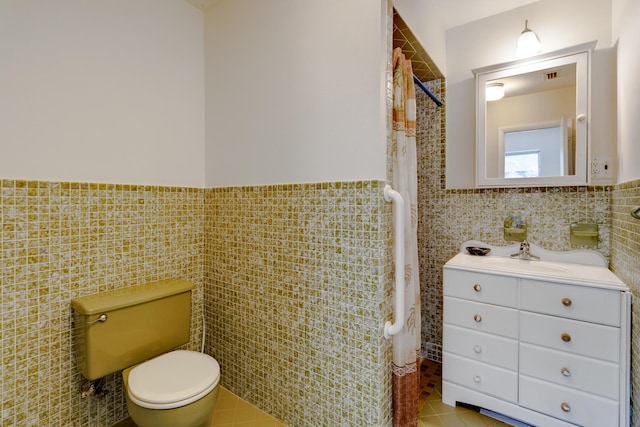 1904 6th Ave SE, Vero Beach, FL 32962 - full bath with tile walls, tile patterned flooring, and toilet