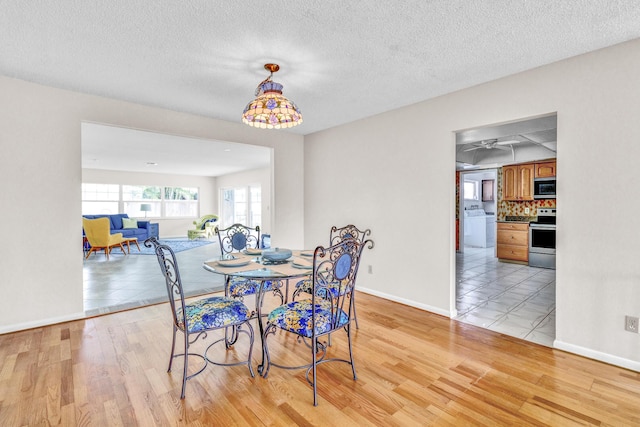 1904 6th Ave SE, Vero Beach, FL 32962 - dining space featuring baseboards, light wood-style floors, and a textured ceiling