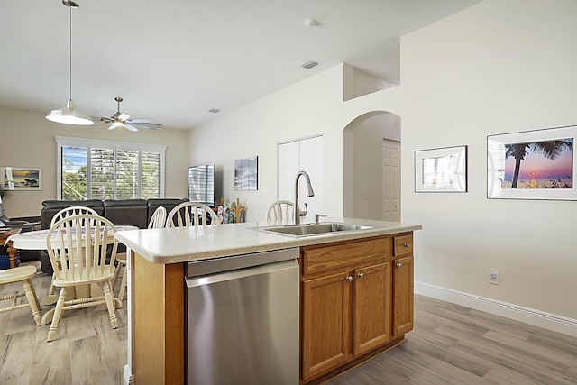 kitchen with visible vents, a sink, light wood finished floors, and dishwasher