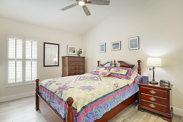 bedroom featuring light wood-style floors, baseboards, ceiling fan, and lofted ceiling