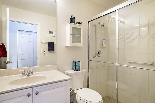 full bathroom with toilet, a shower stall, and vanity