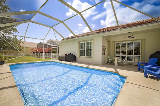 view of pool with fence, a fenced in pool, a ceiling fan, and a patio area