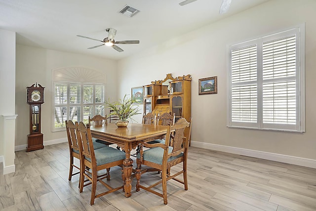 dining space with ceiling fan, visible vents, baseboards, and light wood-style floors