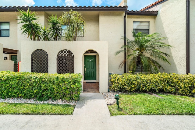 mediterranean / spanish-style home featuring a tile roof and stucco siding