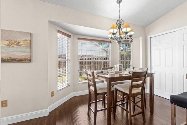 13029 Meadowbreeze Dr, Wellington, FL 33414 - dining room with vaulted ceiling, baseboards, a notable chandelier, and dark wood-type flooring