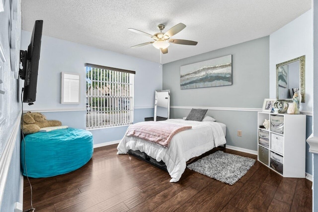 13029 Meadowbreeze Dr, Wellington, FL 33414 - bedroom with baseboards, wood finished floors, a textured ceiling, and ceiling fan