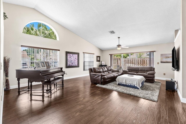 13029 Meadowbreeze Dr, Wellington, FL 33414 - living room featuring a textured ceiling, dark wood-style flooring, baseboards, visible vents, and a ceiling fan
