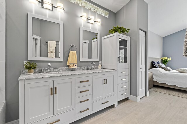17744 Candlewood Ter, Boca Raton, FL 33487 - bathroom with double vanity, a sink, ensuite bathroom, and wood finished floors