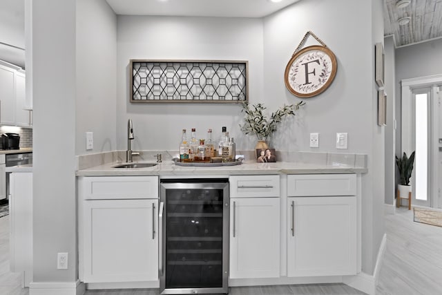 17744 Candlewood Ter, Boca Raton, FL 33487 - bar featuring baseboards, a sink, wet bar, and wine cooler