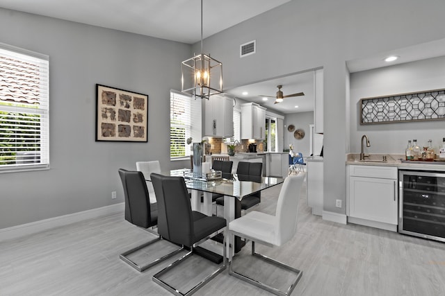 17744 Candlewood Ter, Boca Raton, FL 33487 - dining space with visible vents, wine cooler, baseboards, light wood-style floors, and wet bar
