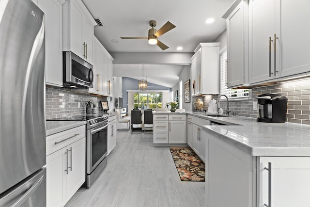 17744 Candlewood Ter, Boca Raton, FL 33487 - kitchen with a sink, appliances with stainless steel finishes, decorative backsplash, and vaulted ceiling