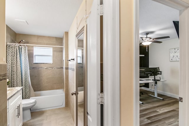 bathroom featuring shower / bath combo, vanity, toilet, and a ceiling fan