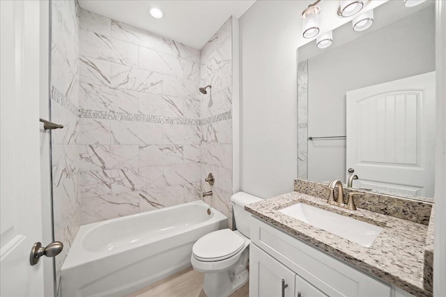 full bath featuring shower / bathing tub combination, wood finished floors, toilet, and vanity